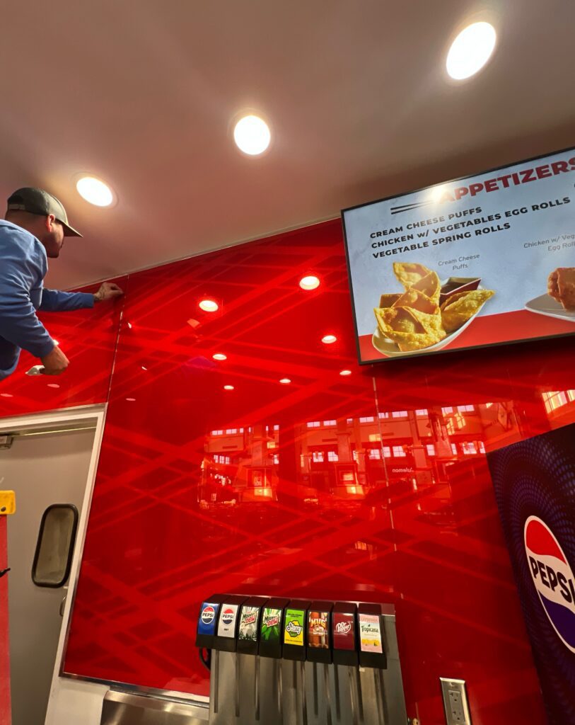 Decorative red panels adorn the walls in the serving area