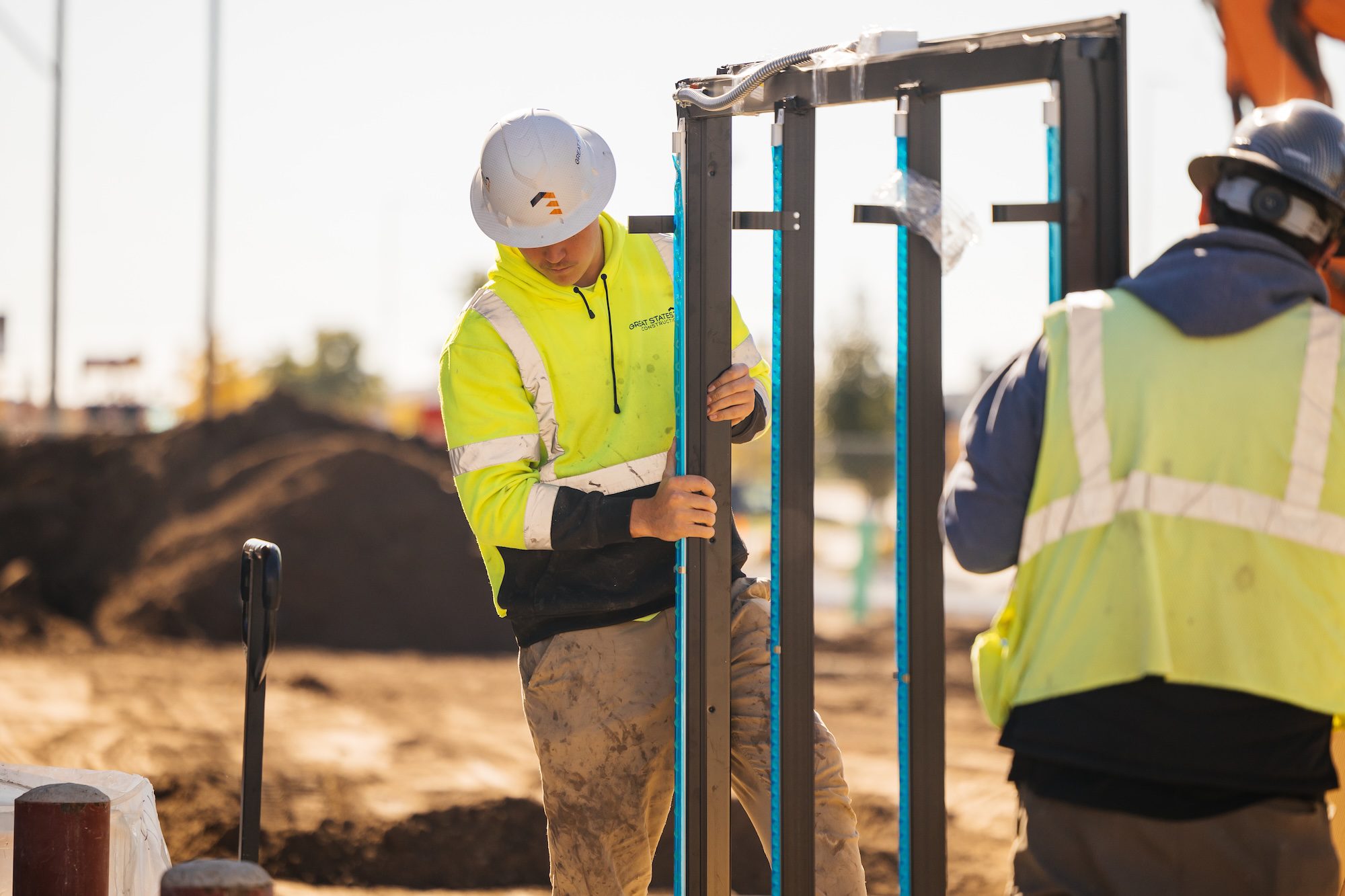 Great States employee on a jobsite wearing a hard hat and high visibility jacket for safety