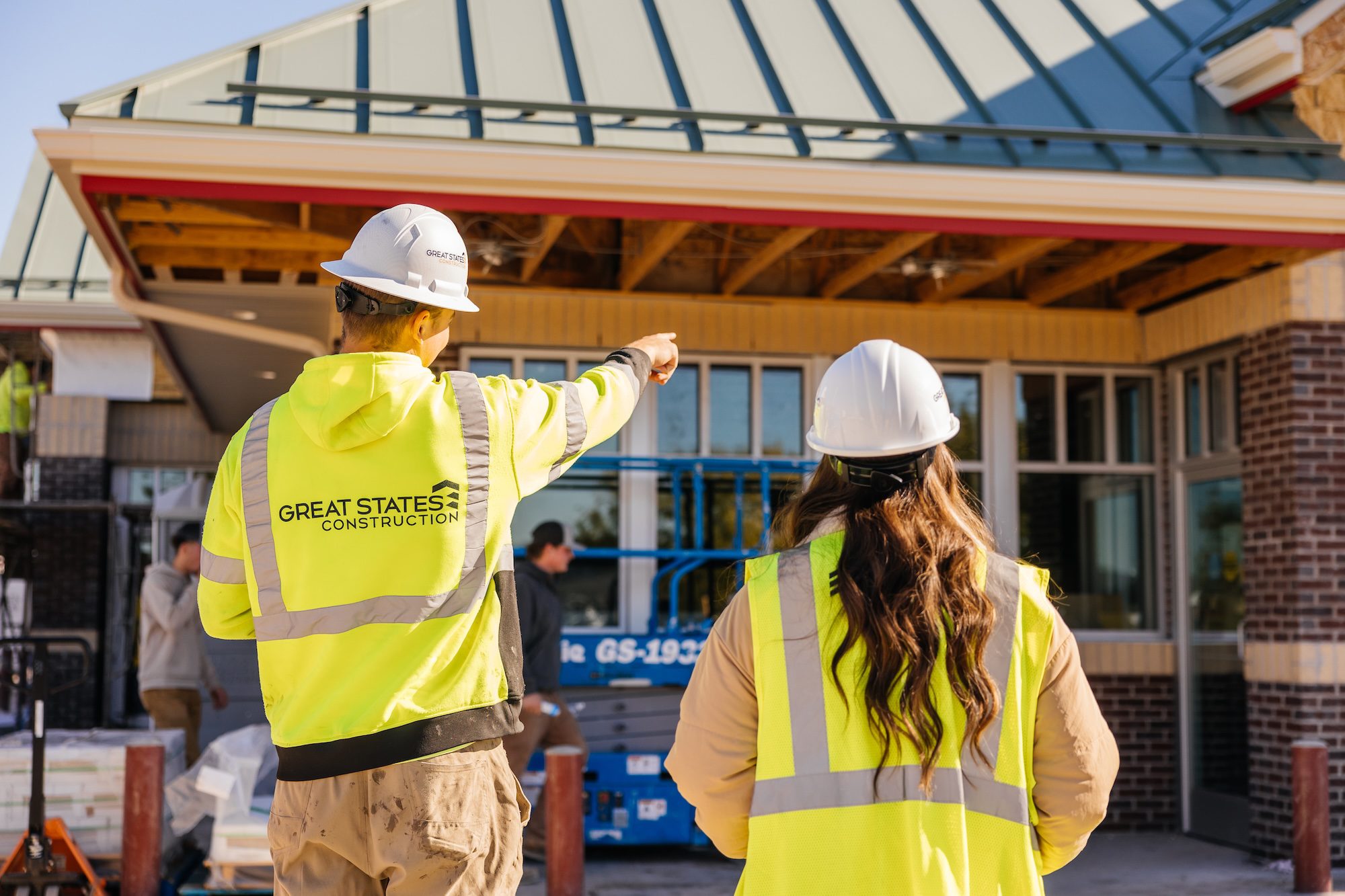 Careers at Great States Construction - Two Team members stand in front of a Kwik Trip under construction