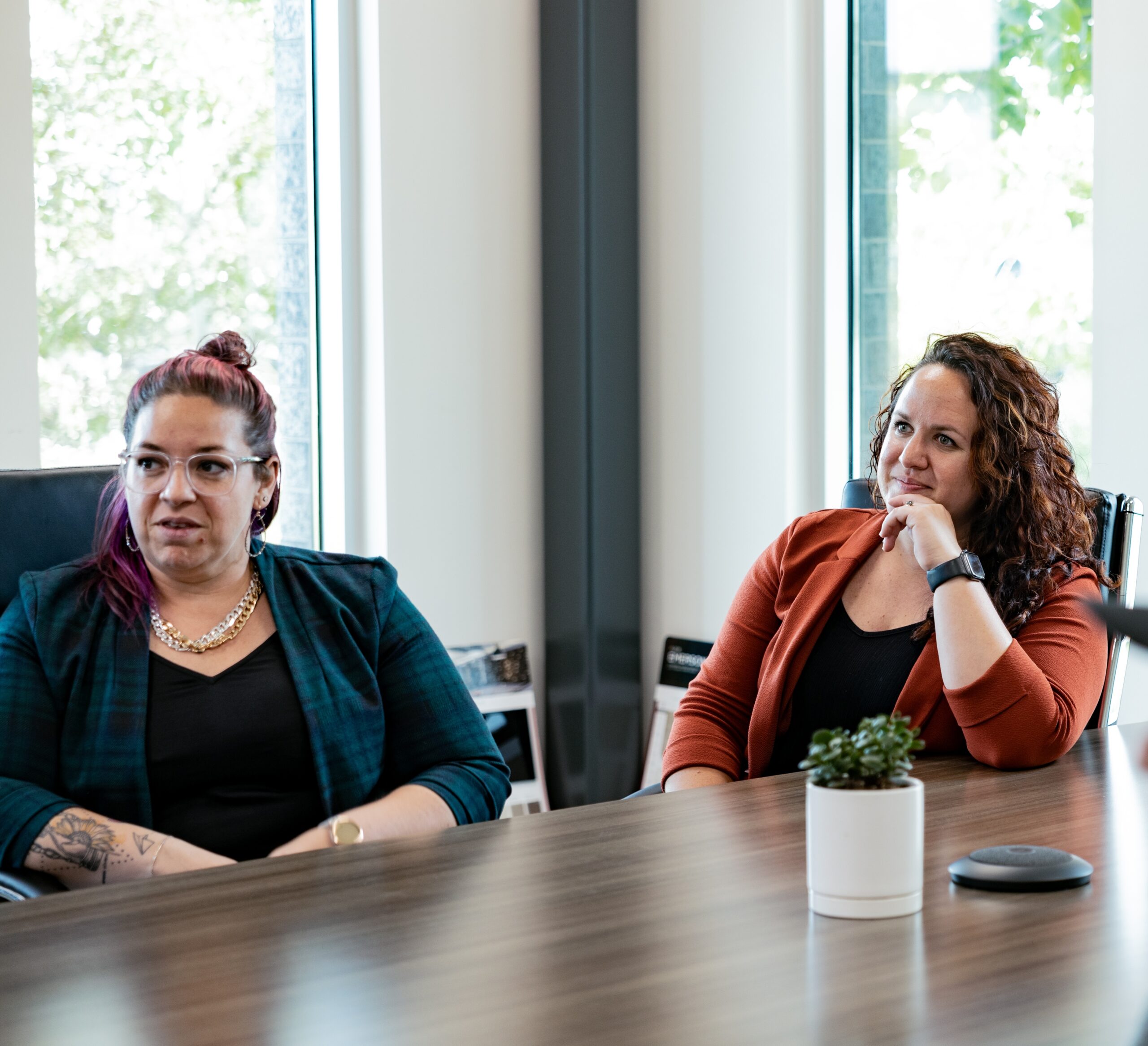 Kayla and Hannah discussing a project at a conference table