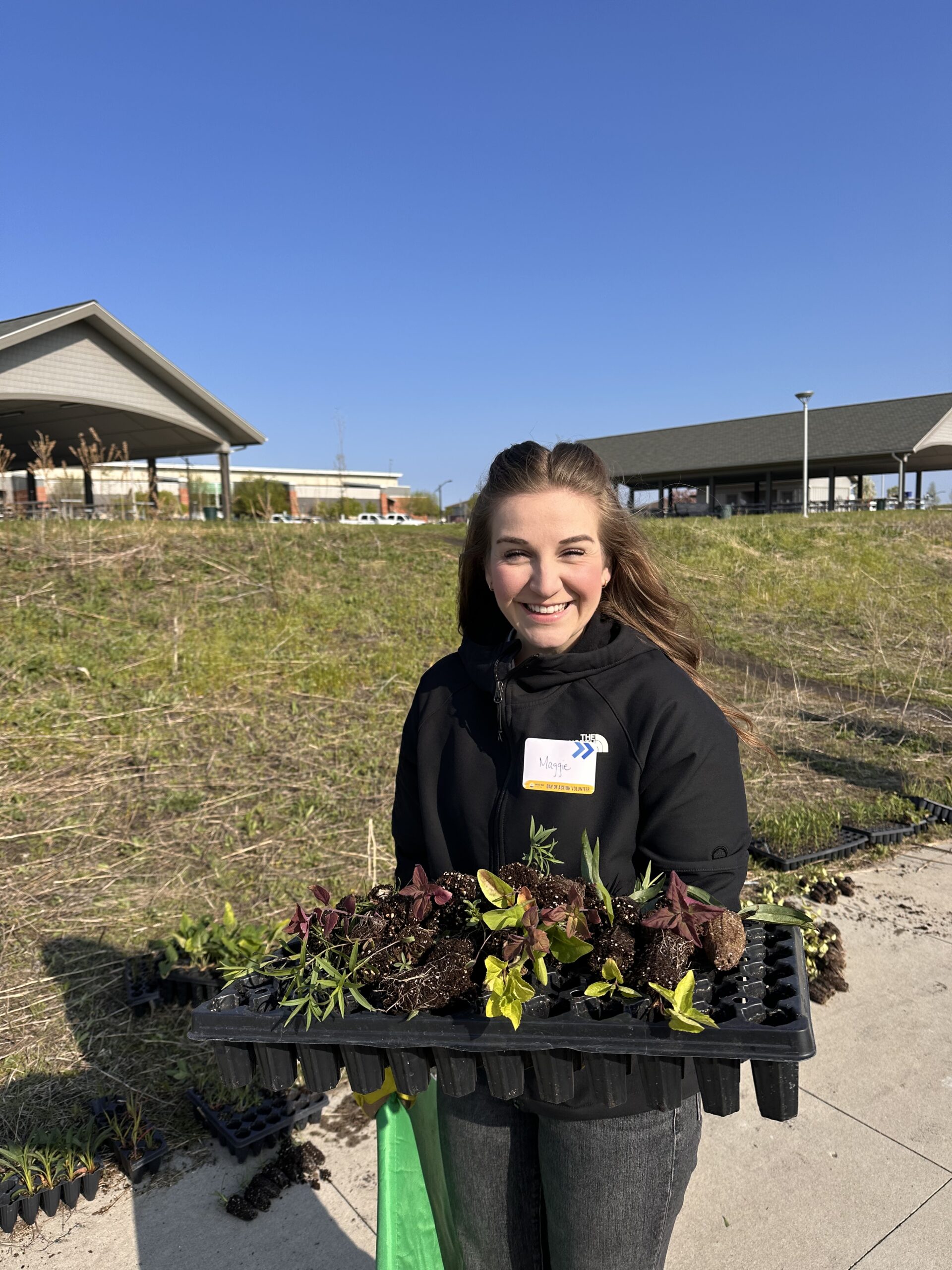 Maggie Nyquist holds a tray of plants