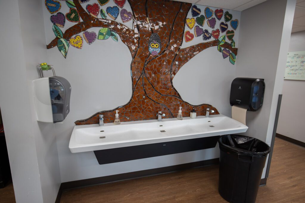 An ADA-compliant sink with colorful tile mural