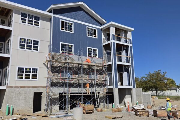 Siding work finishes up on the Village Cooperative of Billings