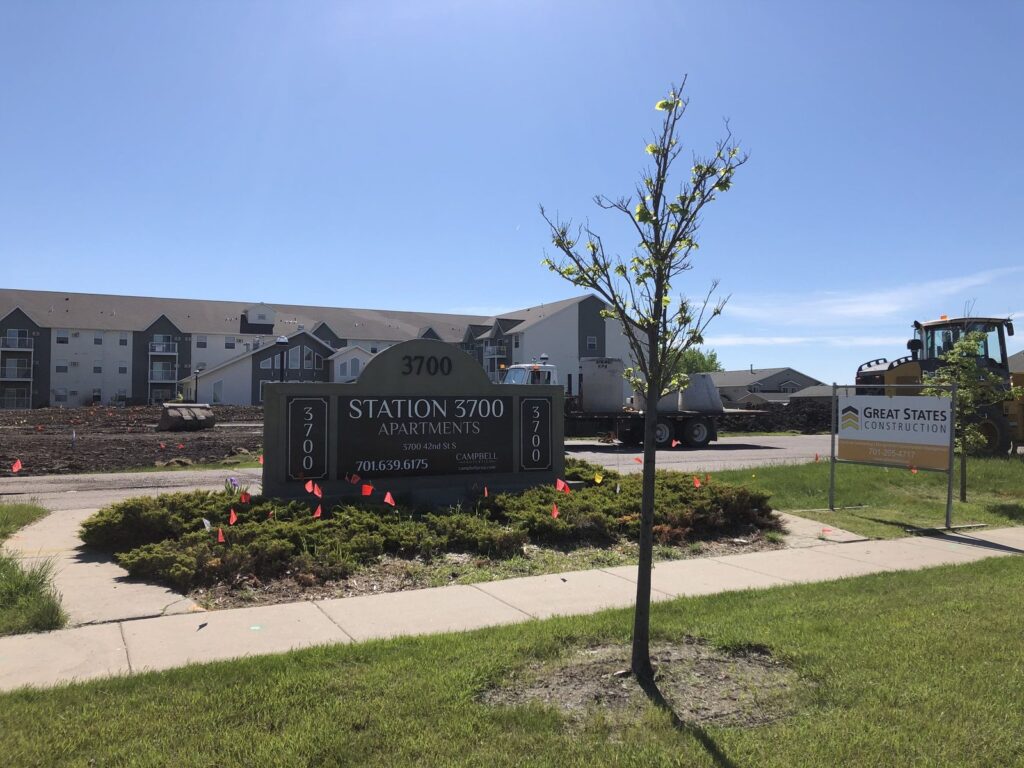 Station 3700 Apartments sign and a Great States Construction job sign at the start of construction in Fargo, North Dakota