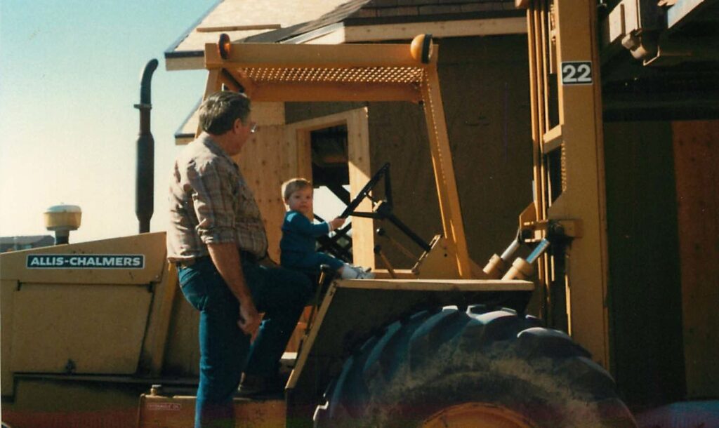 Great States Construction founder as a toddler at the wheel of an Allis-Chalmers loader