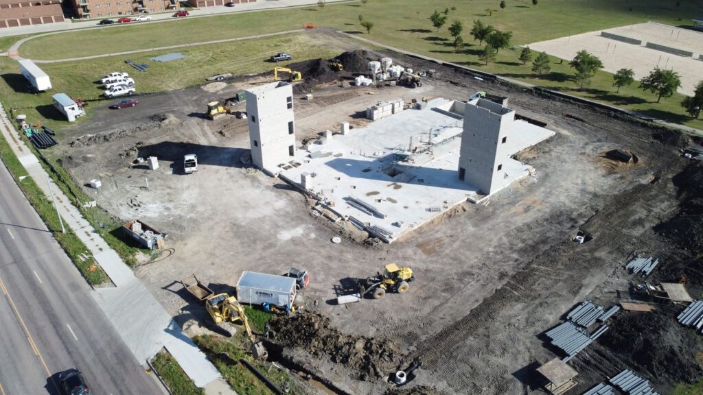 Aerial view of the Red River Human Services Foundation building under construction in Fargo, with stair towers and foundation in place